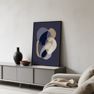 Print leaning on a grey console of prints abstract art with organic shapes in beige and blue and a black vase beside it