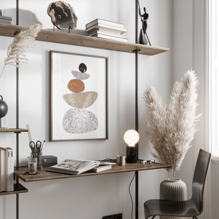 Modern Pebble Print hanging above a wooden desk with a lamp and books in a neutral toned workspace