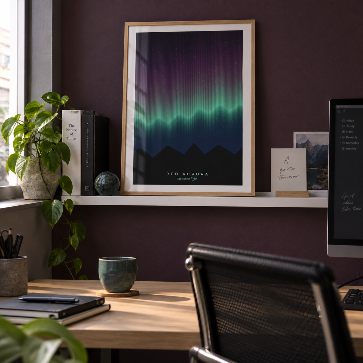 Rare red aurora over mountains print in a home office against an aubergine wall