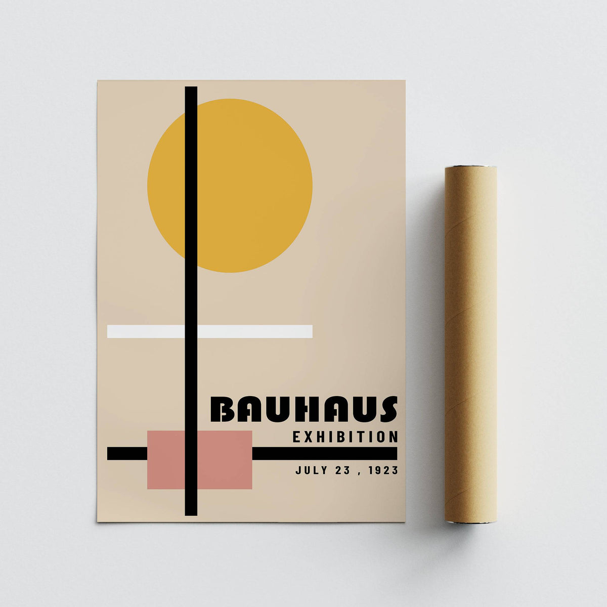 Print laid flat with yellow circle and geometric shapes next to a brown packaging tube