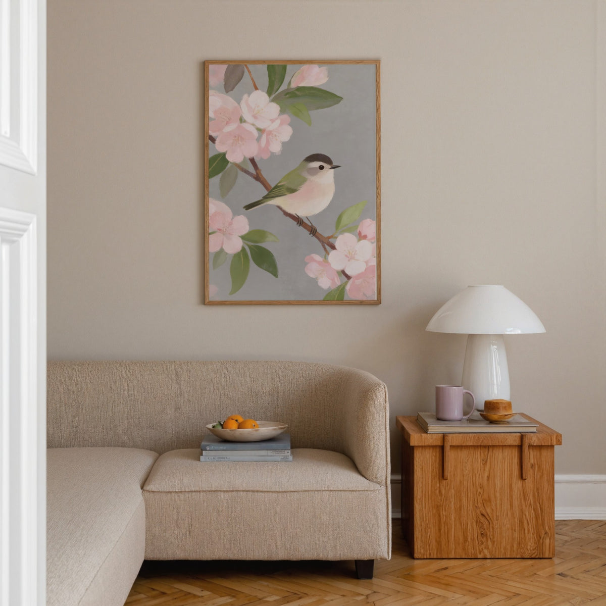 Botanical Bird Wall Art of a small bird on a branch with pink blossoms in a living room above a beige sofa