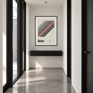 Parallel lines with one red line print above a console table in a hallway