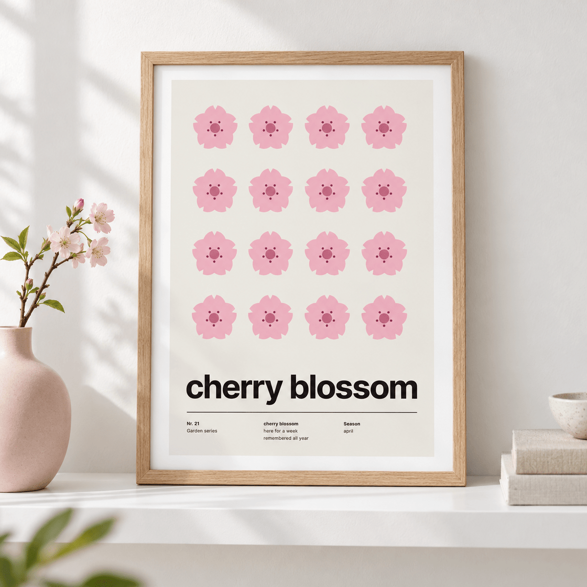 Sixteen pink cherry blossoms in a grid leaning on a shelf with ceramics