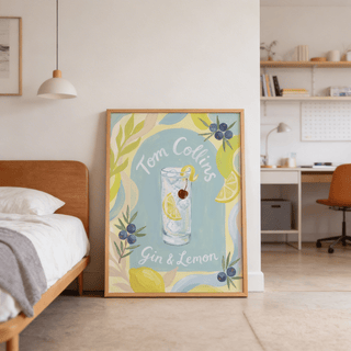 Tom Collins art print leaning on the floor with blue, yellow and green watercolour illustration in a bedroom