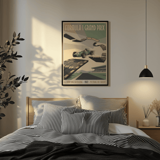 Retro Grand Prix Racing Poster above a bed with striped pillows in a bedroom with pendant light and plant