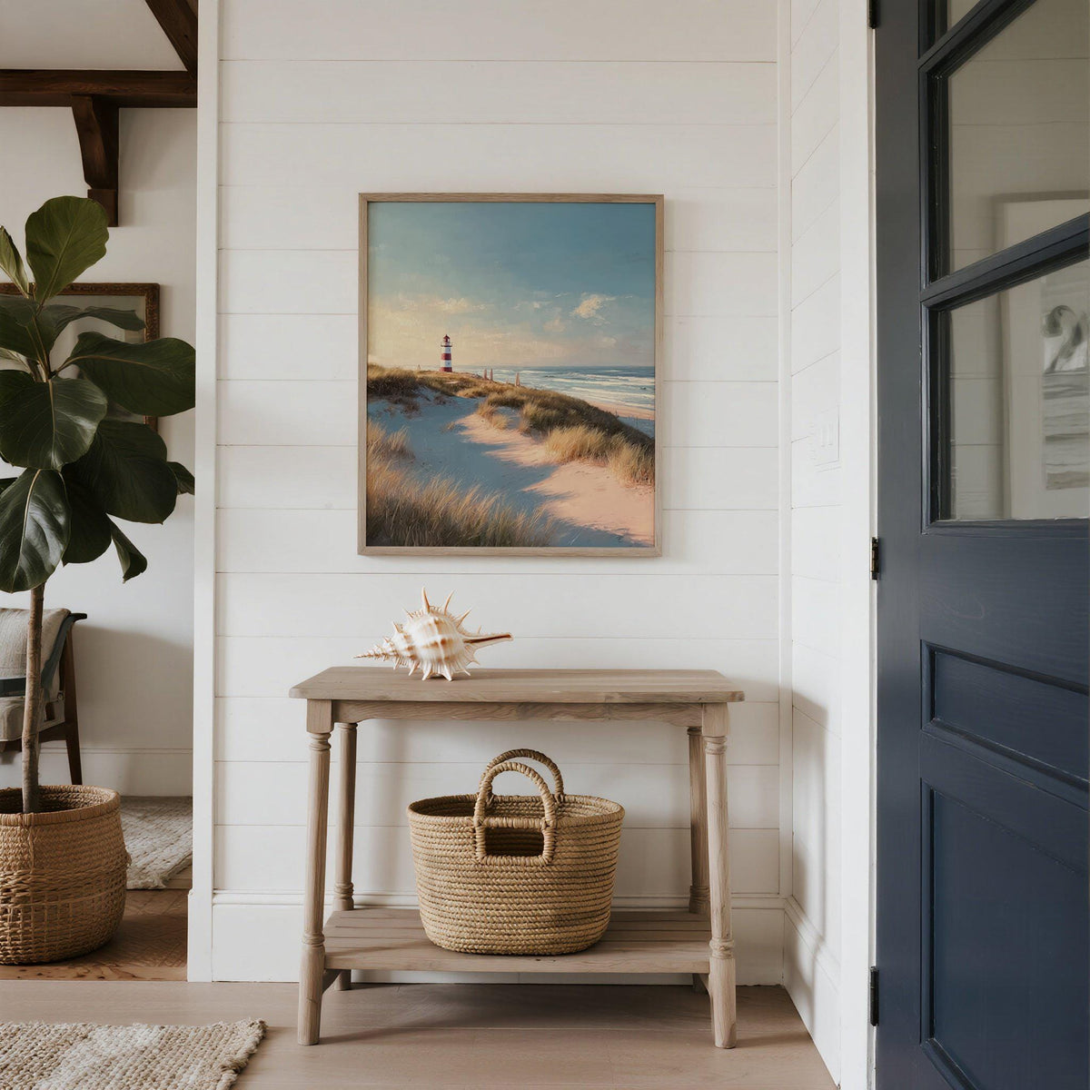 Lighthouse wall art above a wooden table with a seashell and basket in a white hallway