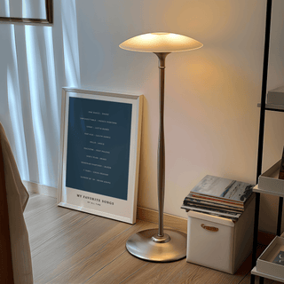 Print leaning on the floor with Custom Song Wall Art featuring a blue background near a lit floor lamp