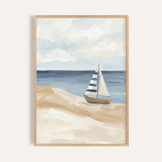 Framed print of a beach sailboat wall art with blue striped sail and sandy shore
