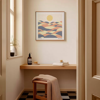 Pastel wall art of abstract hills with a yellow sun in soft pastel colours in a hallway above a wooden shelf