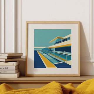 Framed Poolside Art print with modern poolside scene in blue and yellow leaning on a shelf
