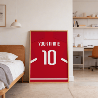 Football Shirt Poster in Red with White Sleeve Stripes leaning on the floor by a bed in a bedroom