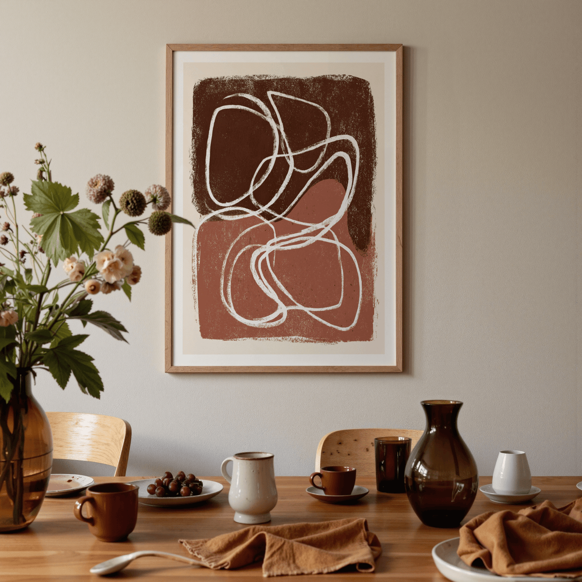 Minimalist Shapes wall art with organic brown and white shapes above a dining table with crockery and a vase