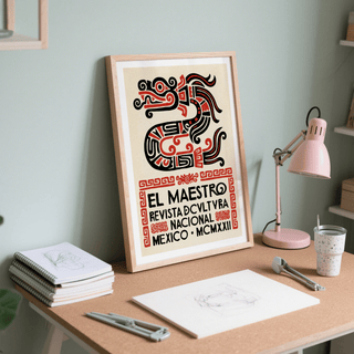Print leaning on a desk of Mexican Cultural Art Print stylised serpent in black and red with text above notebooks and a pink lamp