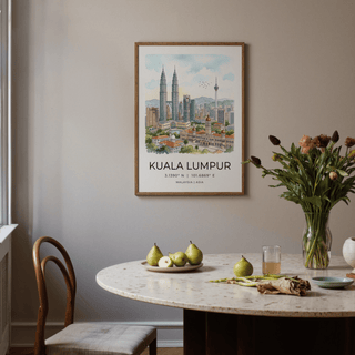 Kuala Lumpur art print on a dining room wall with a marble table and green pears