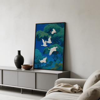 Bird art print leaning on sideboard with vases beside in neutral toned living room