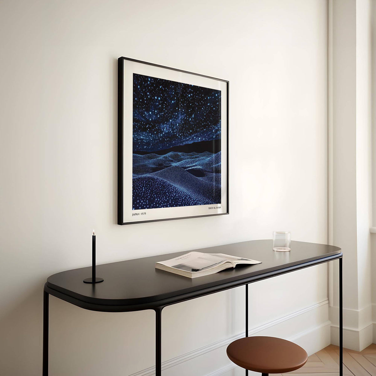 Navy Blue Artwork of a starry night sky with textured hills above a black table with a candle and book