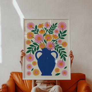 Framed Vase Art Print held in hands showing floral vase with orange and pink flowers and green leaves in natural light