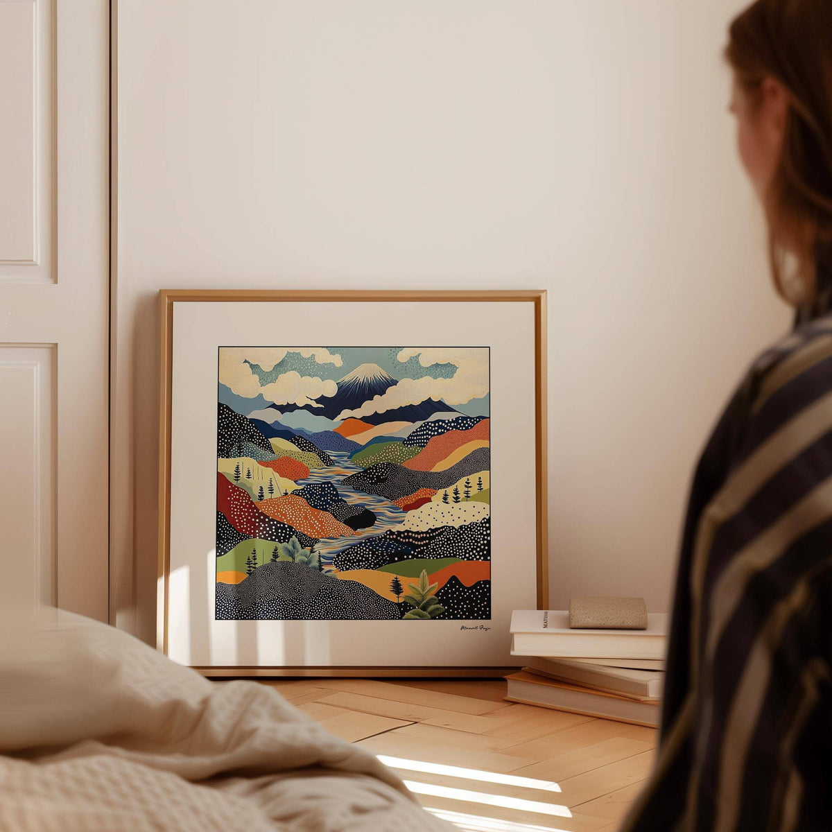 Japanese Art Prints leaning Mount Fuji mountain landscape with bold colours on the floor near books