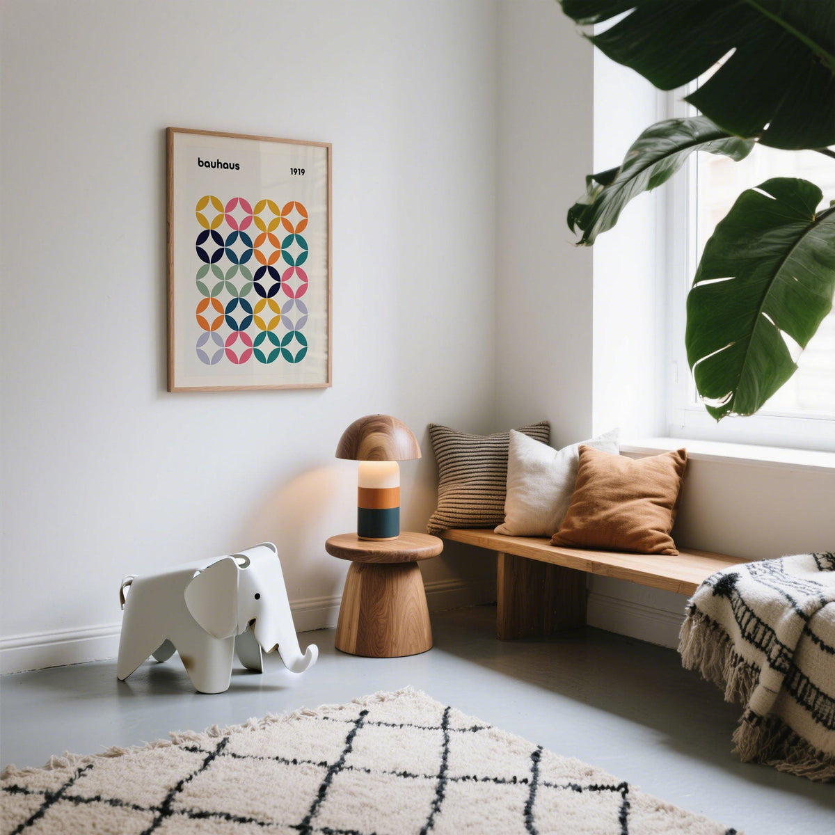 Colorful wall art office with a bauhaus grid pattern in muted pastels and blues above a wooden side table