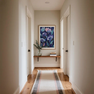 Purple flower poster with abstract purple flowers and teal leaves in a hallway above a shelf with a glass vase