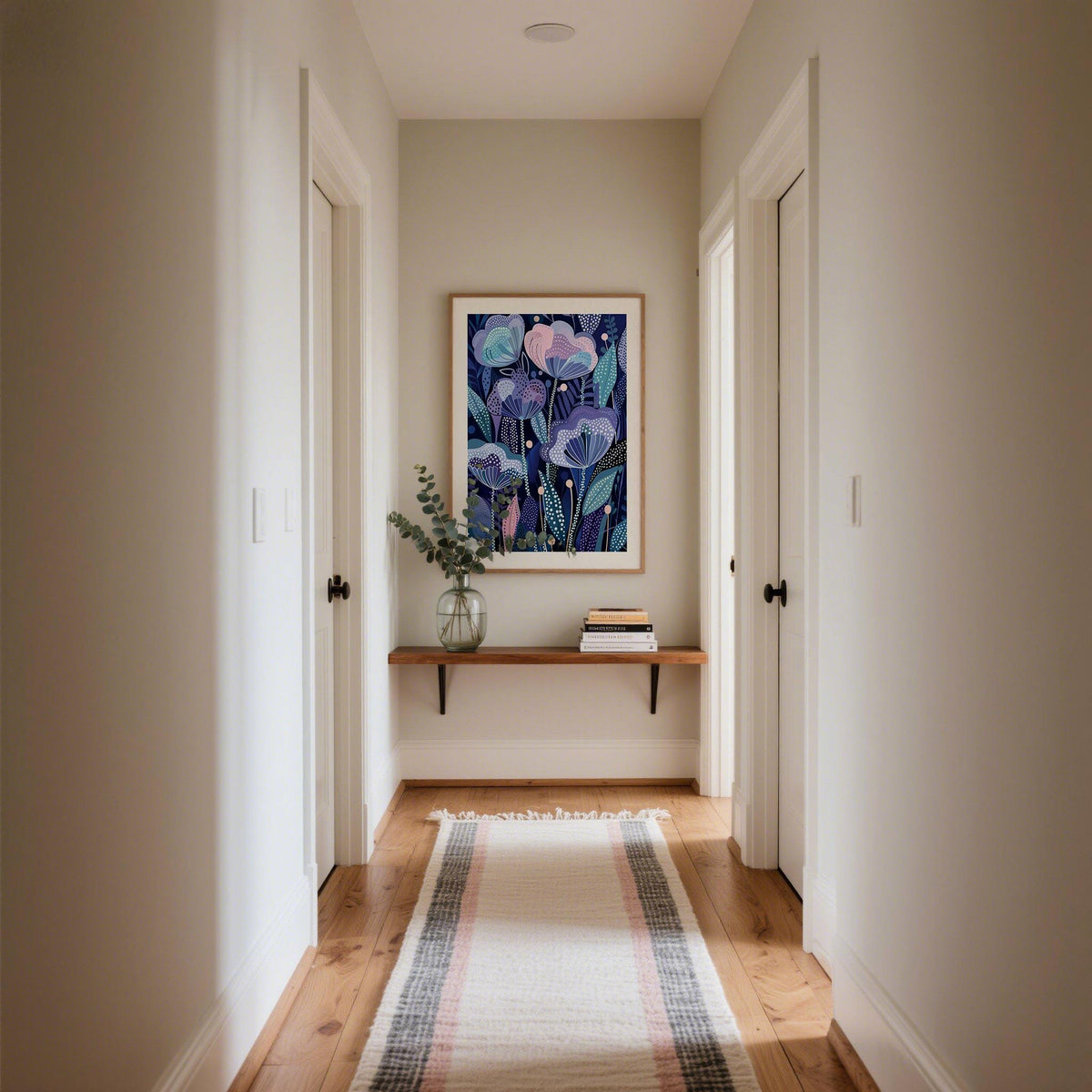 Purple flower poster with abstract purple flowers and teal leaves in a hallway above a shelf with a glass vase