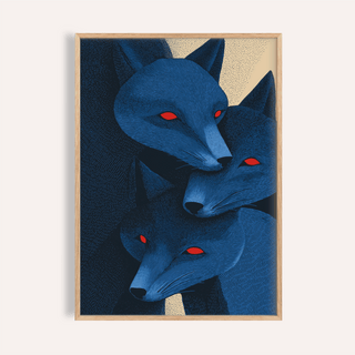Framed print close-up of blue fox prints with three stylised red-eyed fox heads in blue and dark tones