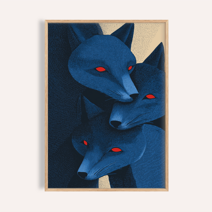 Framed print close-up of blue fox prints with three stylised red-eyed fox heads in blue and dark tones