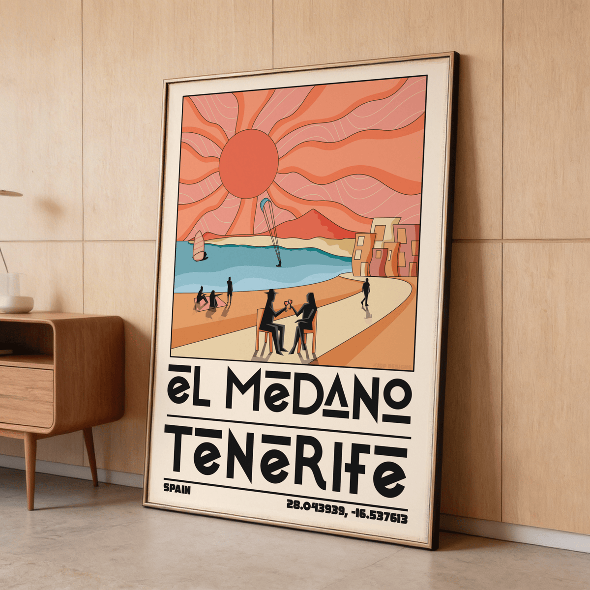Framed Tenerife Travel Poster leaning against a wood-paneled wall showing a retro beach scene with orange sun and blue sea