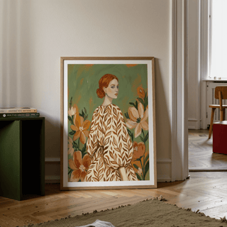 Floral Girl Illustration print leaning on floor by a stack of books with green and orange tones in a modern room