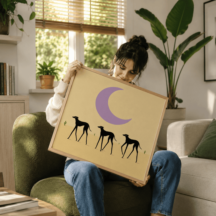 Framed Black Dog Art Print of three black greyhounds under a purple crescent moon held by a woman