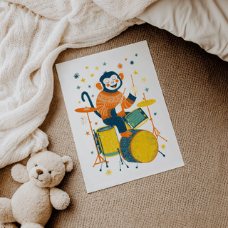 Monkey Drummer art print of a monkey playing drums with yellow and orange details on carpet next to teddy bear