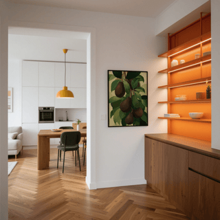 Avocado wall art framed and hung on a white wall beside shelving with orange lighting in a dining area