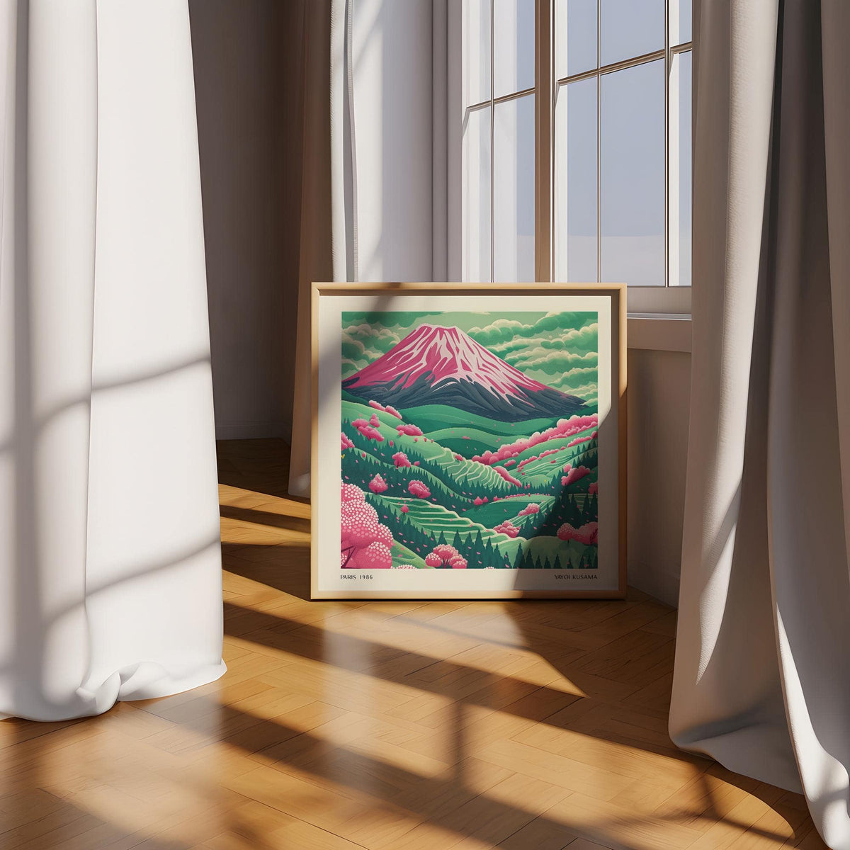 Print leaning on a floor by a window with curtains mountain landscape art showing Mount Fuji with pink cherry blossoms
