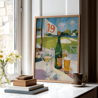 Print leaning on a shelf of a drinks bottle and glasses with golf course background in a light wooden frame