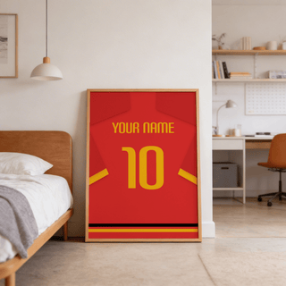 Print leaning on the floor of a bedroom showing a red football shirt poster with yellow number and sleeve stripe