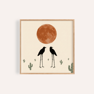 Framed Cactus Bird Wall Art of two black long-legged birds with a large orange moon