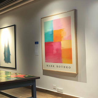 Abstract Art with Pink wall art of colorful blocks in turquoise pink orange hanging in a gallery by a table