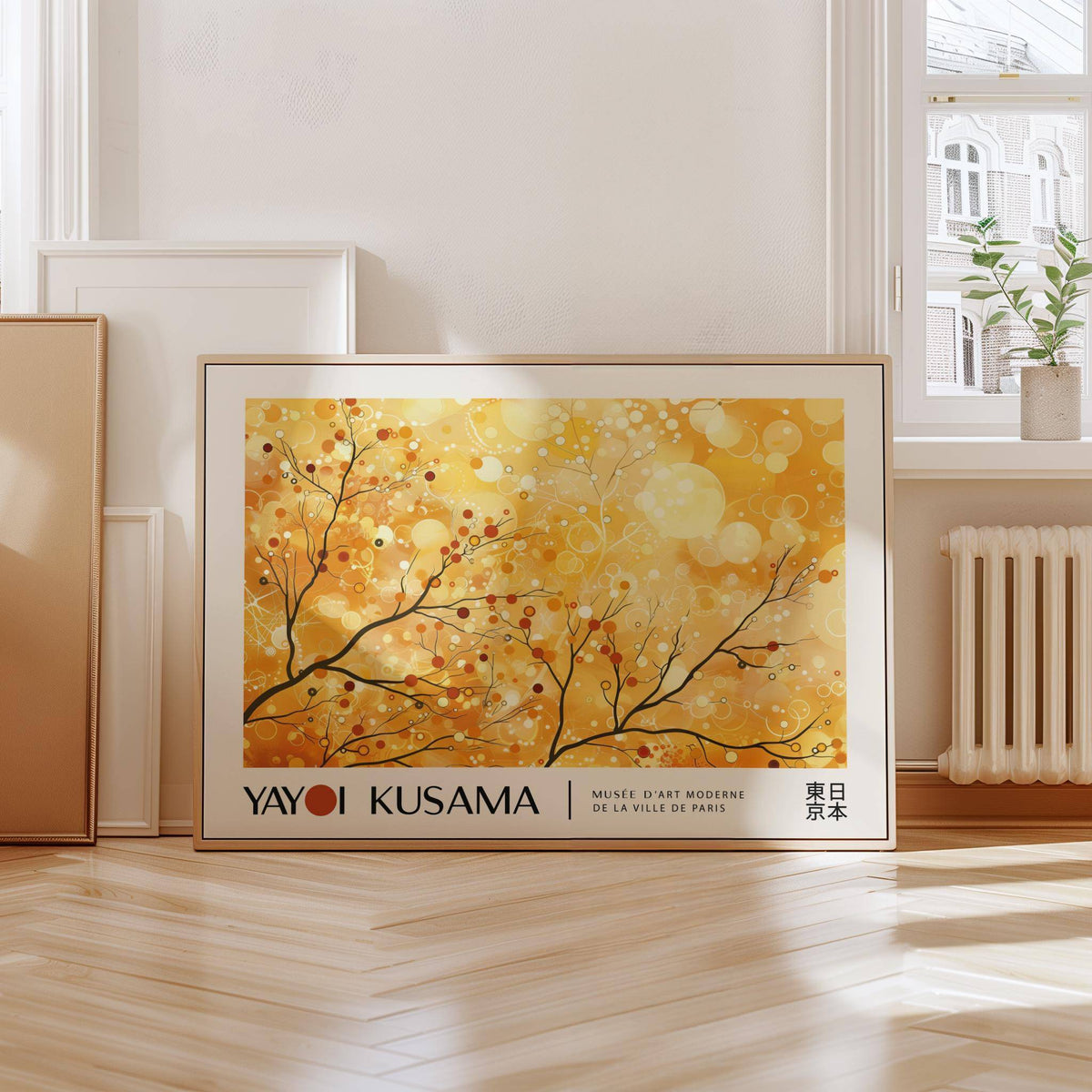 Landscape Poster print leaning on a sunny floor with abstract branches and warm yellow and orange colours near a window with a plant