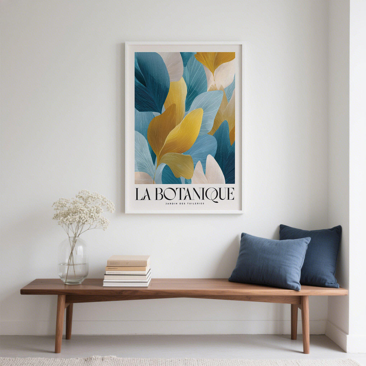 Luxurious wall art of blue and gold botanical leaves above a wooden bench with cushions