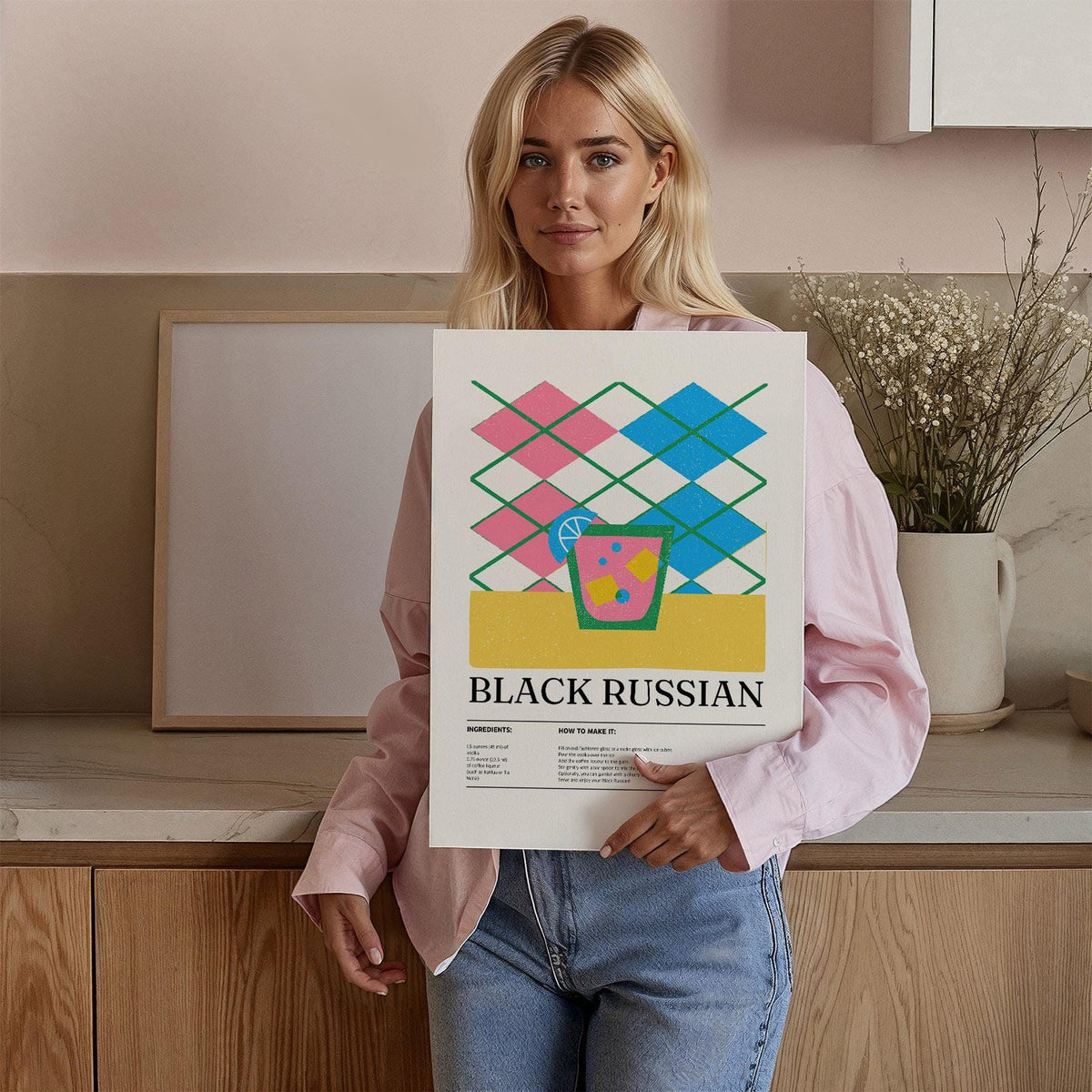 Home Bar Wall Art held by woman with pink blouse showing a minimalist black russian cocktail design