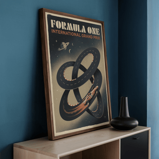 Framed Racing Car wall art with retro illustration in a wooden frame leaning on a shelf next to a black vase
