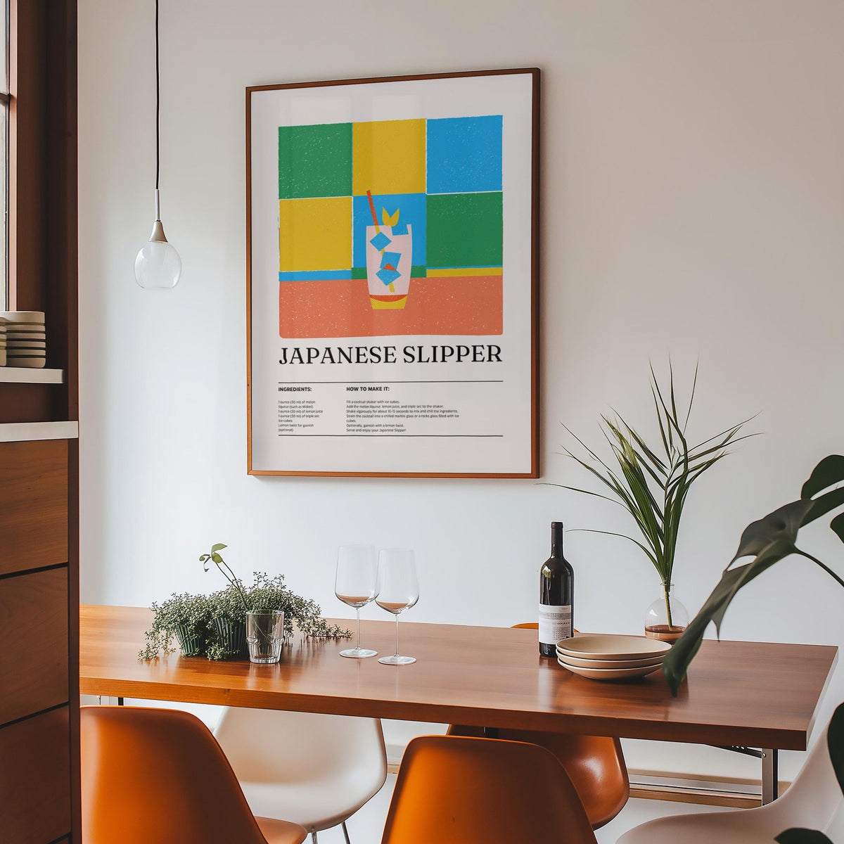 Print on a wall in a dining room showing Japanese slipper cocktail illustration with green and blue blocks above a wooden table