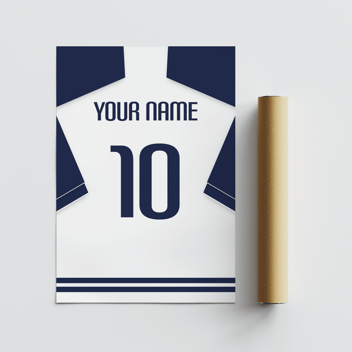 Minimalist white football shirt with navy sleeves and number 10 beside a brown packaging tube