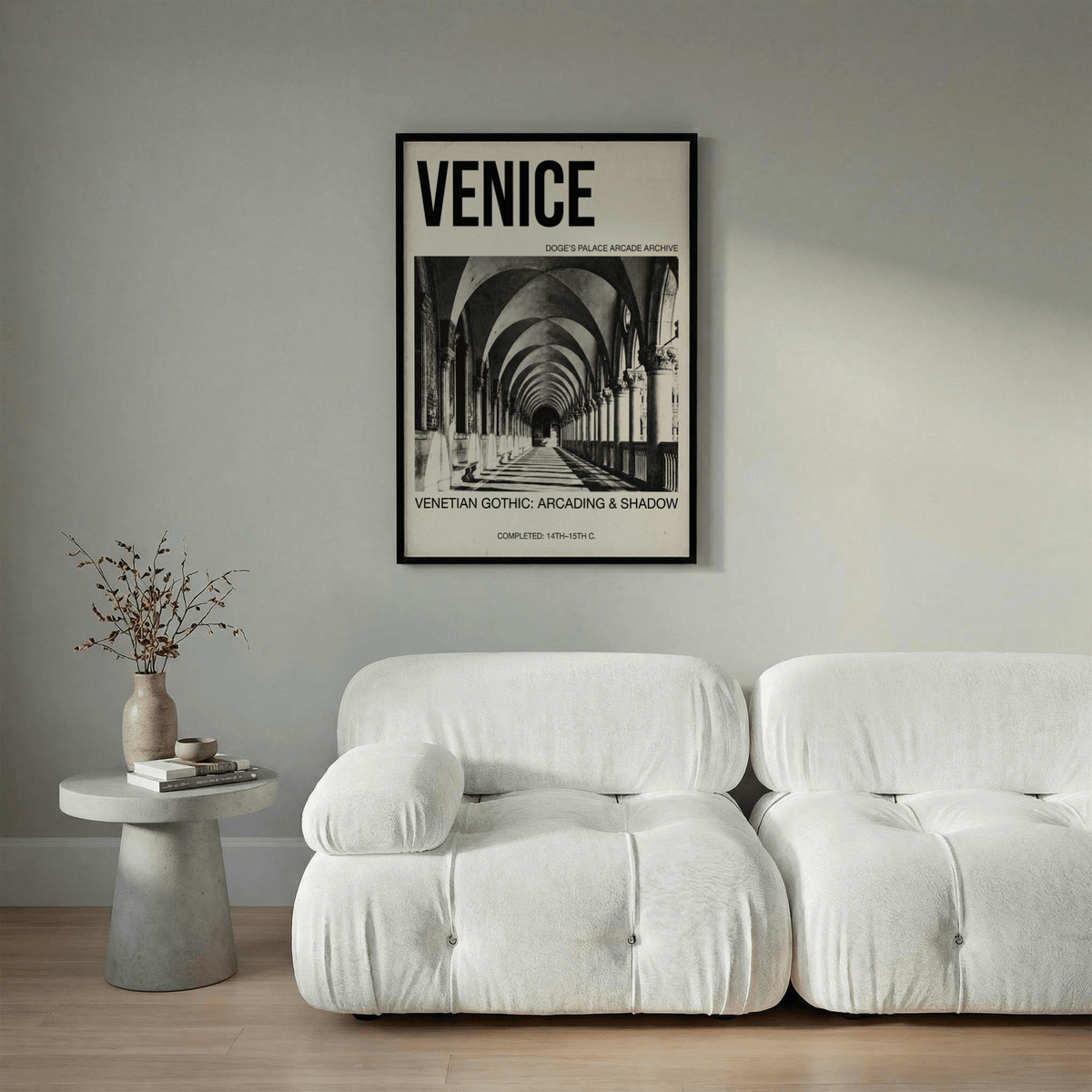 Framed Venetian Gothic wall art with black and white arcade photograph above a white sofa