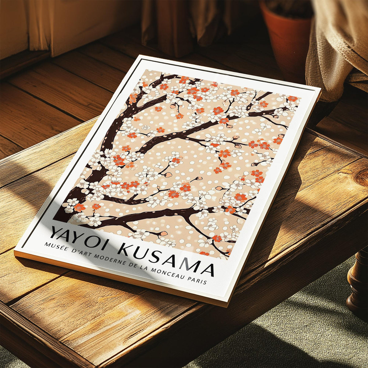 Cherry Blossom Tree Art print leaning on a wooden table with sunlight highlighting the warm beige and orange tones