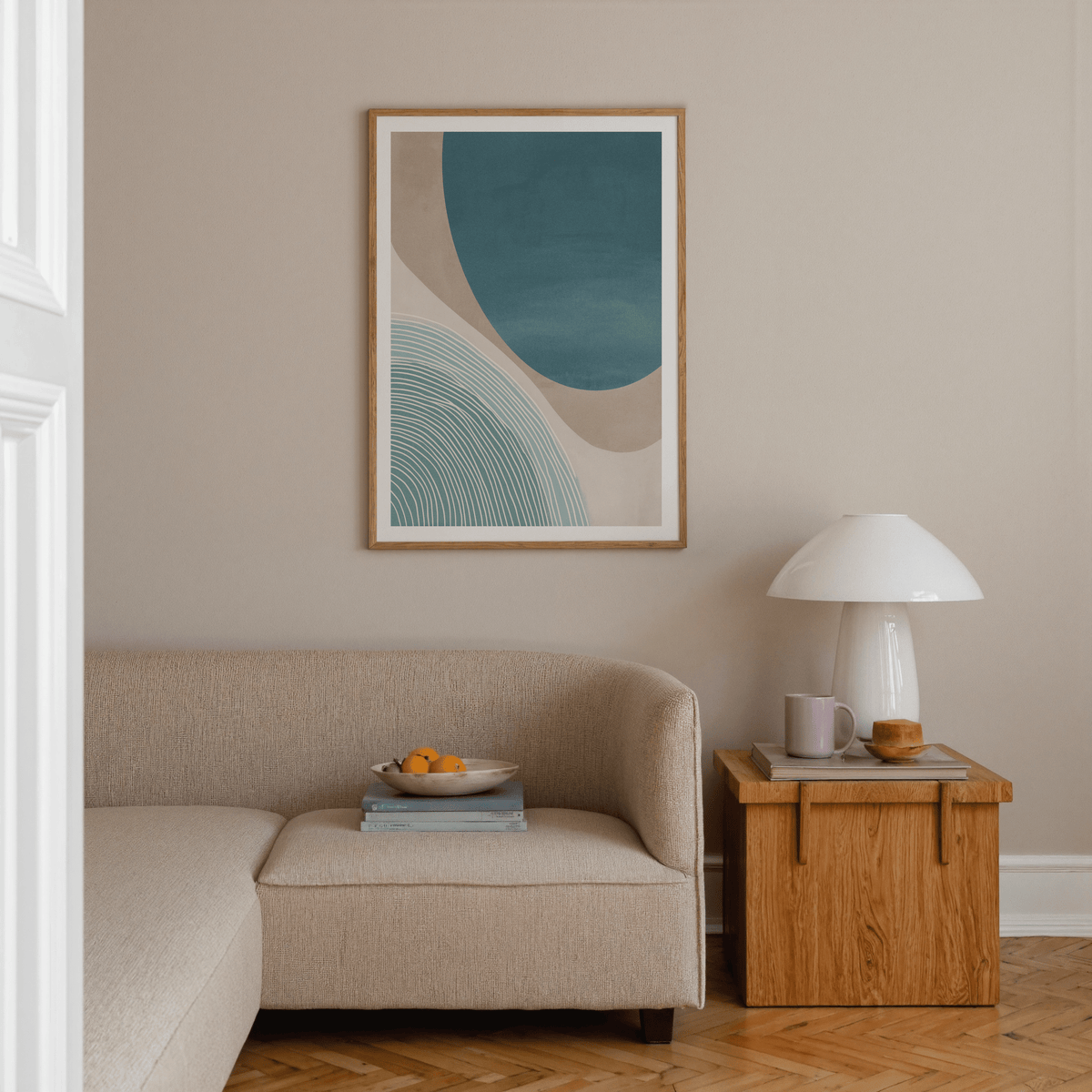 Modern Minimalist Print with abstract blue shapes in a minimalist living room above a beige sofa