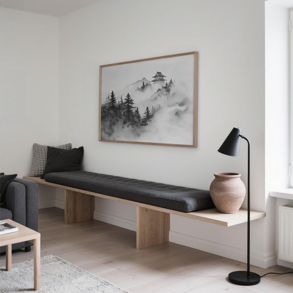 Minimalist mountain art of a Japanese temple in mist with black and grey tones above a bench in a living room