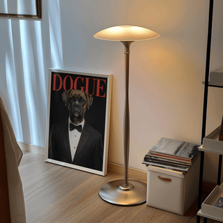 Dogue Poster print leaning on the floor by a silver floor lamp and a stack of records