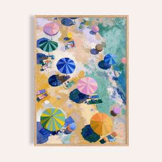 Framed Beach Umbrellas Print with striped umbrella tops in shades of blue, pink, green and orange on a sandy beach