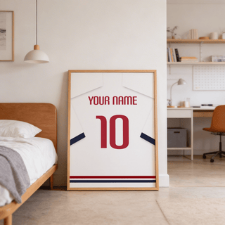 Football Shirt Poster in White with Navy Sleeves and Red Number leaning against wall by a bed
